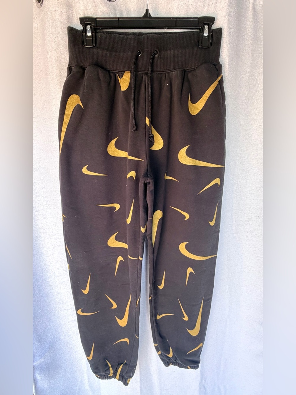 Nike Women’s Black Sweatpants with Gold Swoosh Pattern